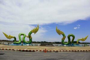 gemelo naga estatua en el azul cielo y blanco nube fondo, en nong khai, tailandia foto