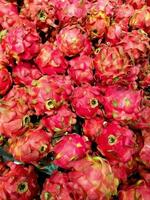 Fresh dragon fruit photographed with a cellphone in a supermarket, Pitaya or pitahaya is the fruit of several different cactus species photo
