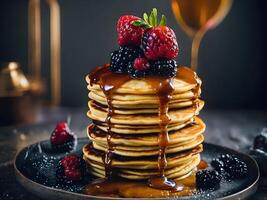 A stack of pancakes with berries and chocolate syrup. photo