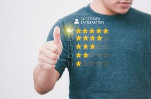 Satisfaction survey and customer service concept, businessman using a smartphone to answer the questionnaire and give a satisfaction rating, offering a 5-star satisfaction rating photo