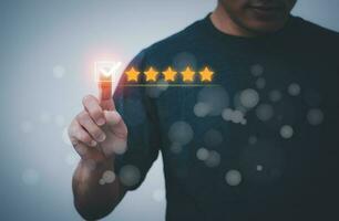 Satisfaction survey and customer service concept, businessman using a smartphone to answer the questionnaire and give a satisfaction rating, offering a 5-star satisfaction rating photo