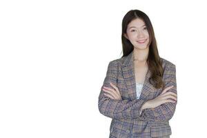 Asian professional woman with black long hair wearing plaid suit stand with arms crossed and pretty smiling looking at camera is present product isolated on white background. photo