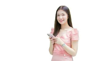 Asian professional young business woman with long hair is smiling in the garden while looking at the camera holding smartphone in her hand with isolated on white background. photo