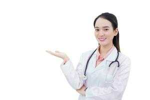 Professional young Asian woman doctor shows her hand to present something while looking at the camera isolated on white background. photo