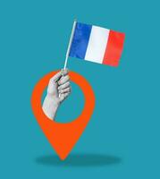 Art collage, Hand with the flag of France and a navigation icon on a blue background. photo