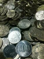 Shining and Glowing Stacked Collection of Old Indonesian Rupiah Coins photo