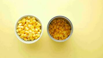 Sweet corns in a bowl and a tin container on yellow video