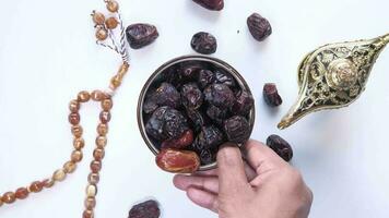 the concept of ramadan, Man hand putting bowl of date fruit on table video