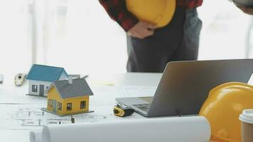 Business objects of team engineers office with construction engineer architect and worker looking building model video