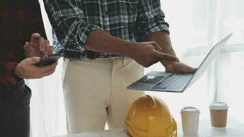 Business objects of team engineers office with construction engineer architect and worker looking building model video