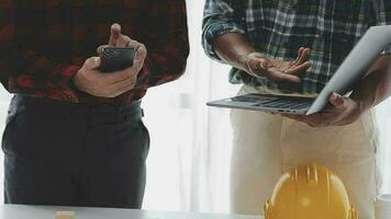 Business objects of team engineers office with construction engineer architect and worker looking building model video