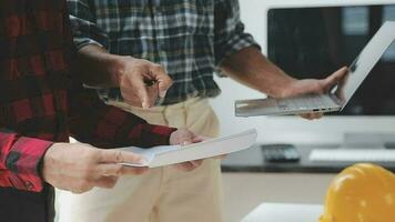 Business objects of team engineers office with construction engineer architect and worker looking building model video