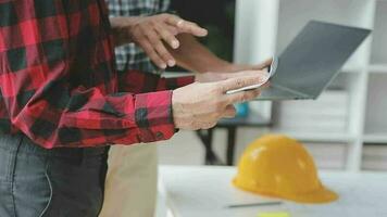 Business objects of team engineers office with construction engineer architect and worker looking building model video