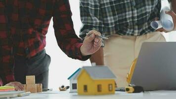 Business objects of team engineers office with construction engineer architect and worker looking building model video