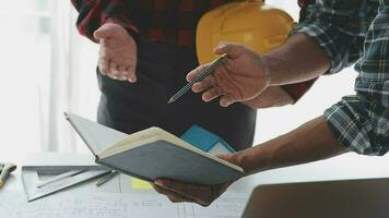 Business objects of team engineers office with construction engineer architect and worker looking building model video