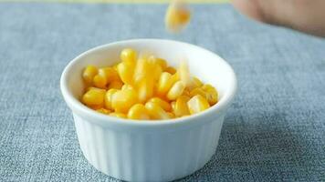 slow motion of Sweet corns drops in a bowl on table video