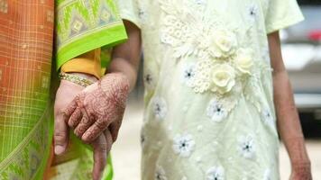 Child girl holding hand her grandmother hand at local park video