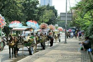 jakarta, indonesia-23 april 2023 delman base on the edge of the city road photo