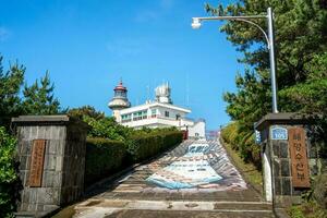 Udo, Jeju island, South Korea - Jun. 06, 2023. Beautiful Udo Lighthouse at Udobong peak, Udo mountain, beside Jeju do ,Jeju island. photo