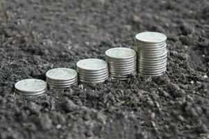 Close-up side view of stacked coins, stacked coins on the ground photo