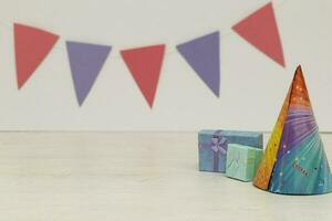Two birthday gift box and hat on wood background photo