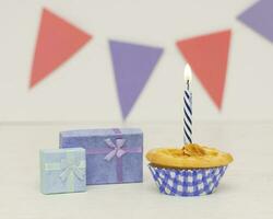 Two birthday gift box with cupcake on wood background photo
