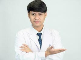 Asian man student scientist or doctor one person, wearing a white gown, standing, looking and smiling, white background with a stethoscope auscultating the heart around his neck. photo