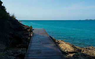 Landscape summer panorama view front pathway Wooden for tourists Walk and enjoy nature along the hills Rocks and the sea Clear blue sky Rayong Thailand photo