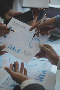 Financial analysts analyze business financial reports on a digital tablet planning investment project during a discussion at a meeting of corporate showing the results of their successful teamwork. photo