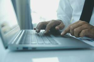 Close up businessman hand using calculator and working with laptop calculate about finance accounting at coffeeshop outdor.finance accounting concept photo