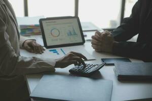 Audit concept,Administrator business man financial inspector and secretary making report calculating balance. Internal Revenue Service checking document. photo