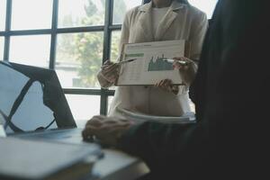 Audit concept,Administrator business man financial inspector and secretary making report calculating balance. Internal Revenue Service checking document. photo