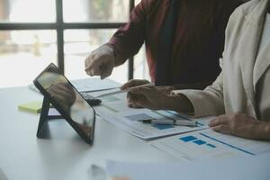 Audit concept,Administrator business man financial inspector and secretary making report calculating balance. Internal Revenue Service checking document. photo