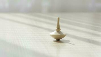 Spinning top moving on a table. Closeup video
