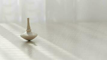 Small spinning top moving on a table. Closeup video