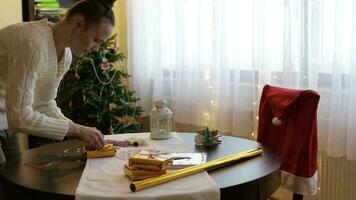 Young lady prepares Christmas gifts for her relatives video