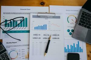 Close up of accountant working and analyzing financial reports project accounting with chart graph and calculator in modern office  finance and business concept. photo