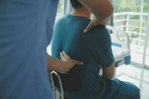 Physiotherapist working with patient in clinic photo