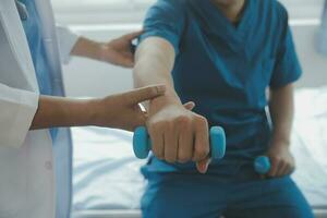 Physiotherapist working with patient in clinic photo