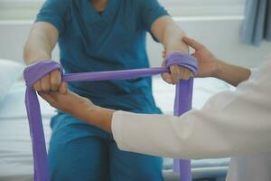 Physiotherapist working with patient in clinic photo