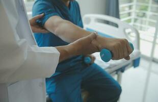 Physiotherapist working with patient in clinic photo