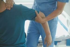 Physiotherapist working with patient in clinic photo