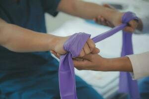 Physiotherapist working with patient in clinic photo