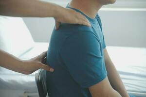 Physiotherapist working with patient in clinic photo