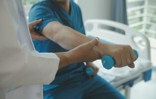 Physiotherapist working with patient in clinic photo