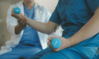 Physiotherapist working with patient in clinic photo