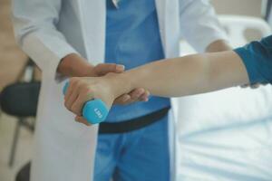 Physiotherapist working with patient in clinic, closeup photo