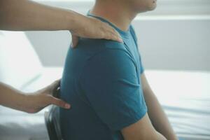 Physiotherapist working with patient in clinic, closeup photo