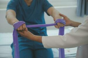 Physiotherapist working with patient in clinic, closeup photo