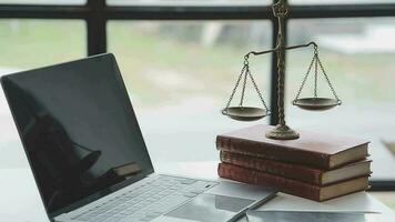 Justice and law concept.Male judge in a courtroom with the gavel, working with, computer and docking keyboard, eyeglasses, on table in morning light video